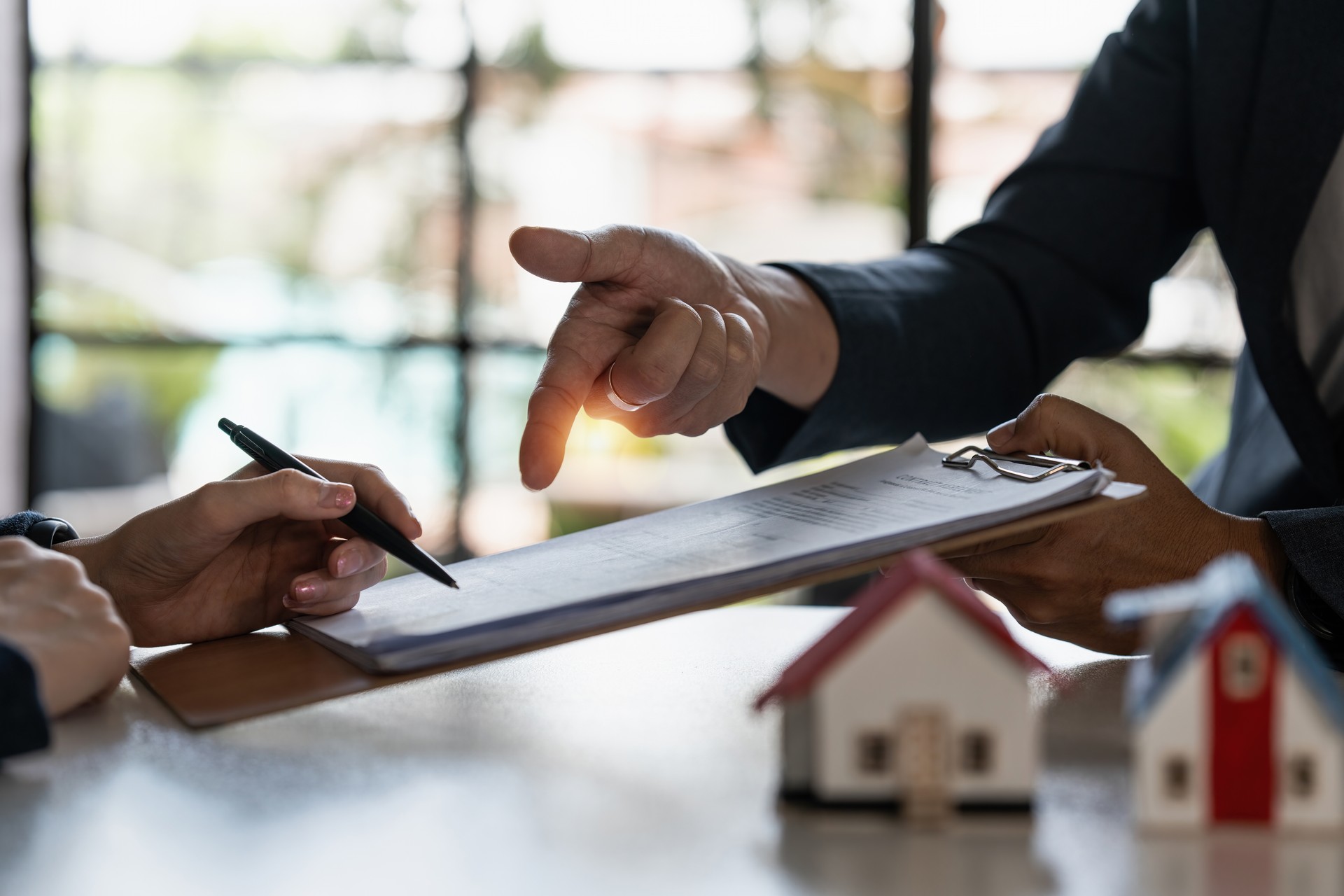 Real estate concept. Businessman pointing at agreement contract.